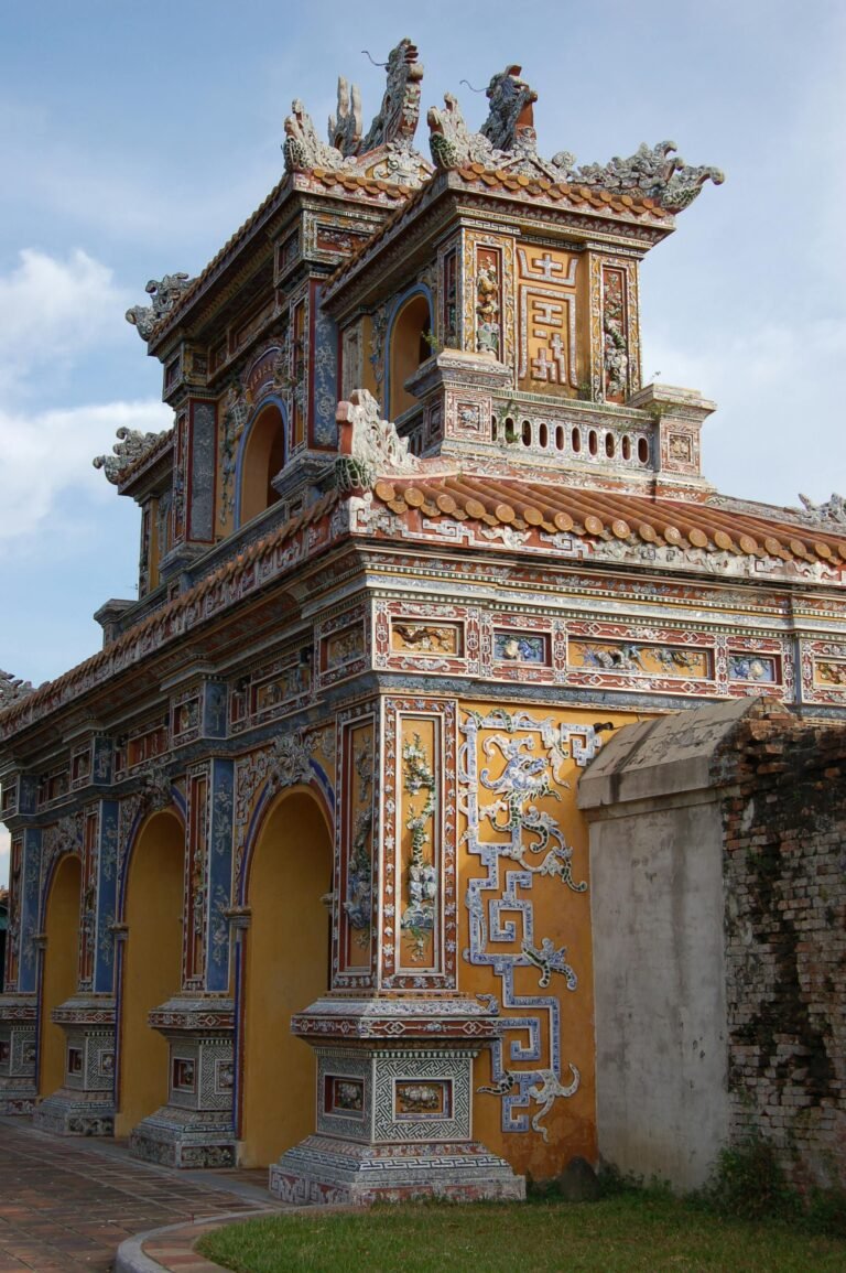 A beautifully ornate temple gate in Hue, Vietnam showcasing intricate architectural details.