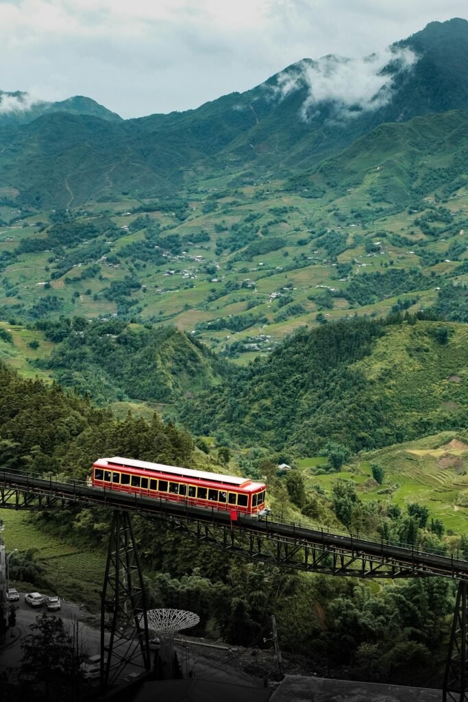 Picturesque train crosses lush valleys and mountains in Lao Cai, Vietnam.