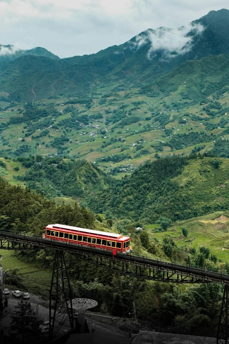Picturesque train crosses lush valleys and mountains in Lao Cai, Vietnam.